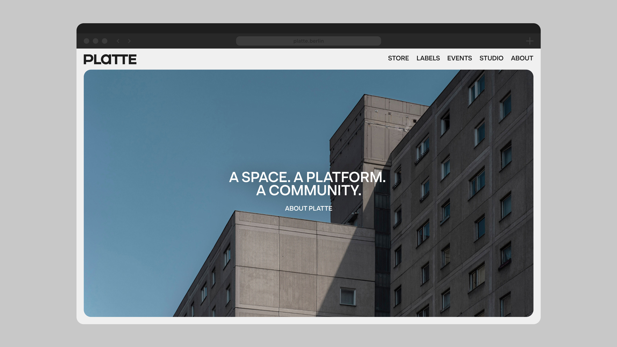 A screenshot of the new PLATTE website, showing a large photo of brutalist buildings, with the text overlayed: “A space. A platform. A community.”