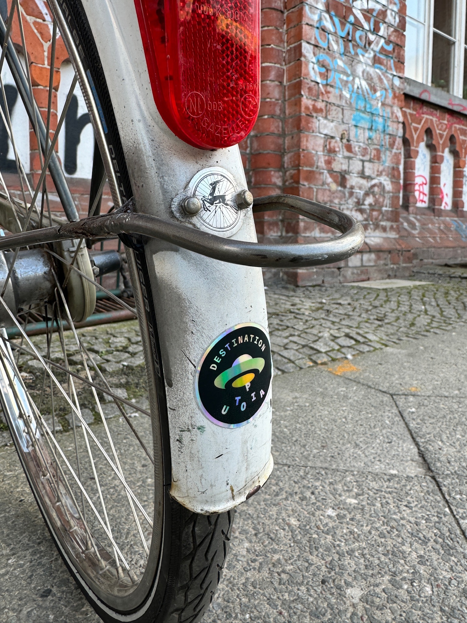 Photo of a bicycle with a sticker that says “Destination Utopia”