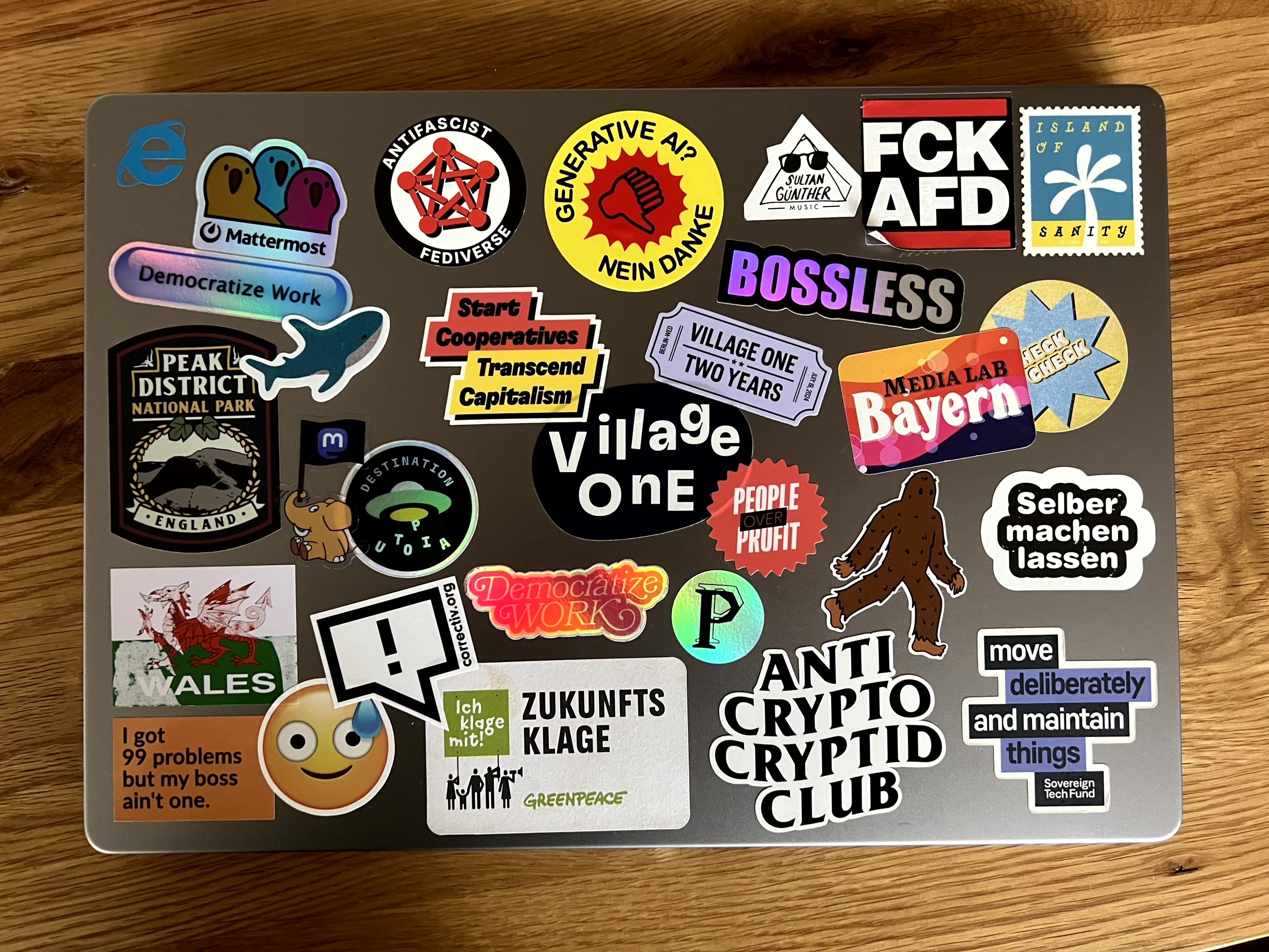 Photo of a laptop lid with a ton of stickers with progressive messages on it